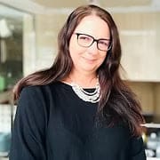 Smiling woman with glasses in office setting